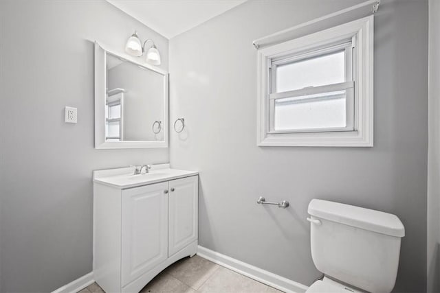 bathroom featuring tile patterned flooring, vanity, and toilet