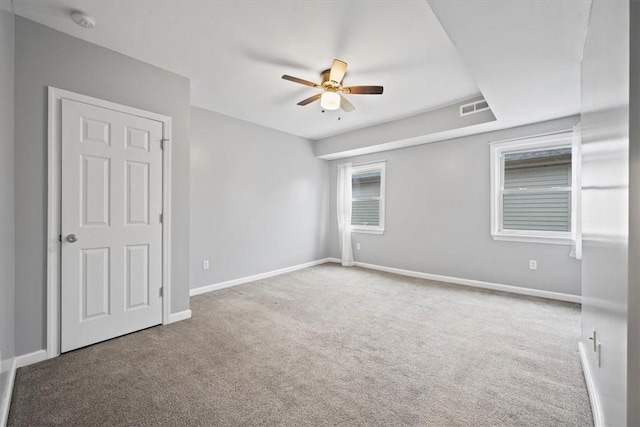 carpeted spare room with ceiling fan