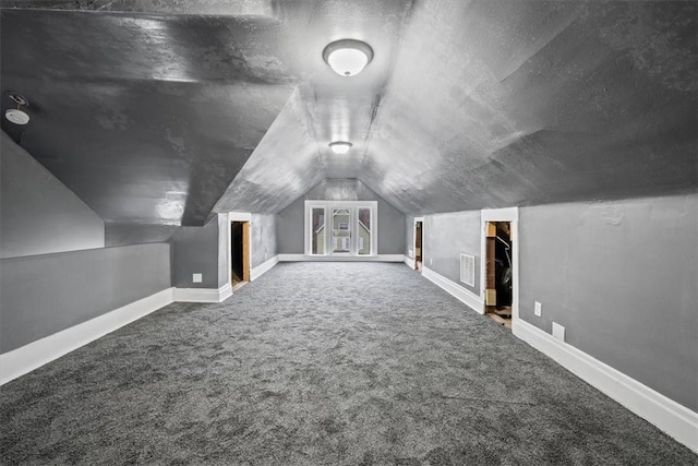 bonus room with carpet, a textured ceiling, and lofted ceiling