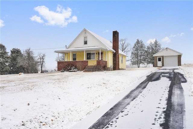 view of front of house featuring an outbuilding, a porch, and a garage