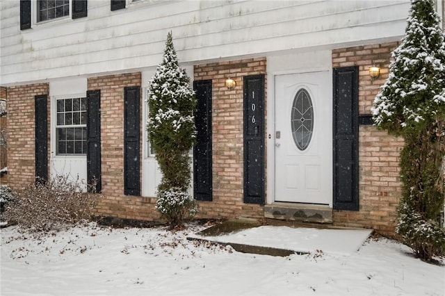 view of snow covered property entrance