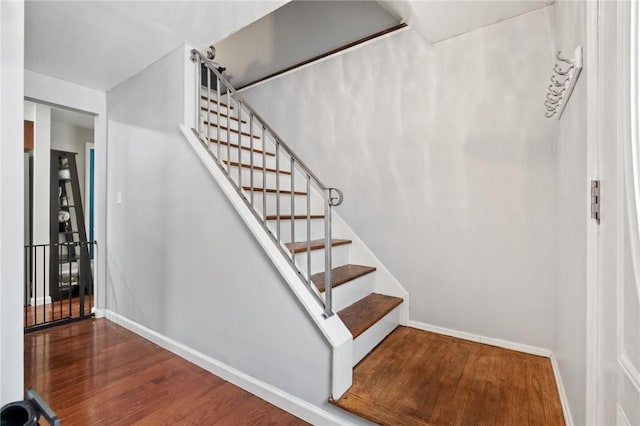 stairway with hardwood / wood-style floors