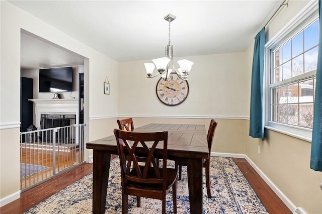 dining space featuring a chandelier and dark hardwood / wood-style flooring