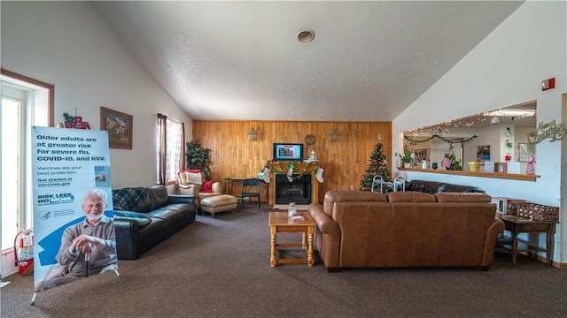 carpeted living room featuring vaulted ceiling and wooden walls