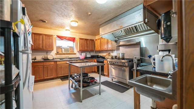 kitchen with stainless steel range, a textured ceiling, white refrigerator, black dishwasher, and range hood