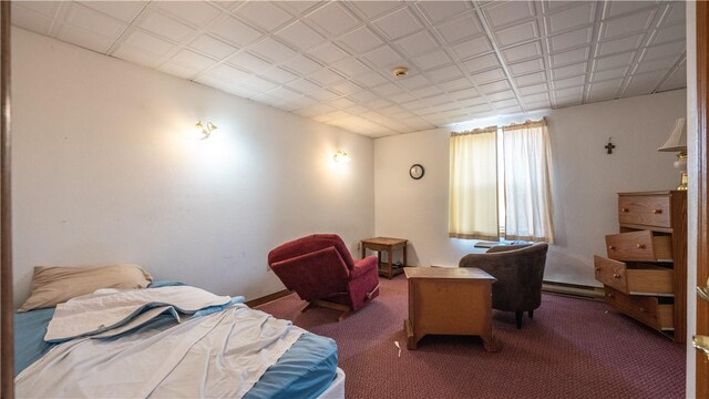 carpeted bedroom featuring a baseboard heating unit