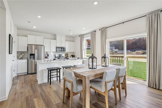 dining space with light hardwood / wood-style flooring