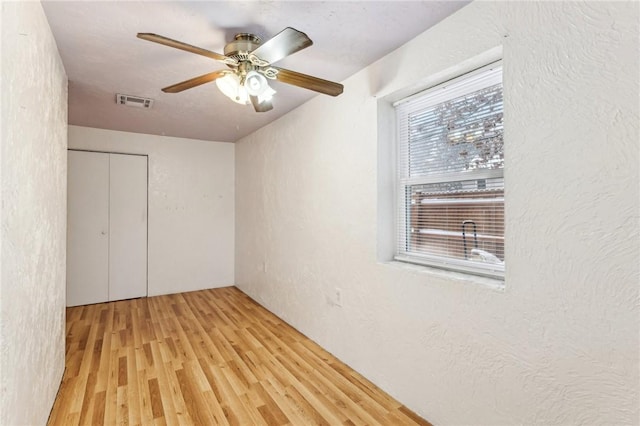 unfurnished room with ceiling fan and light hardwood / wood-style floors