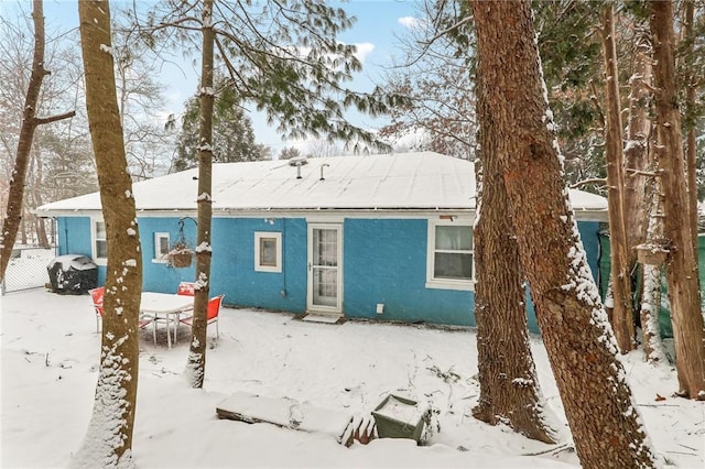 view of snow covered rear of property