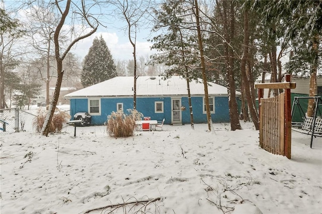 view of snow covered back of property