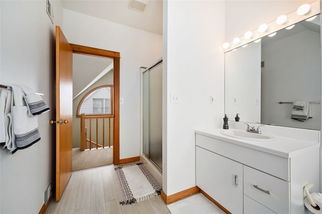 bathroom featuring vanity, wood-type flooring, and walk in shower