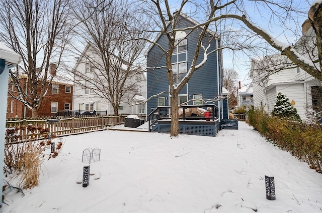 snowy yard with a deck