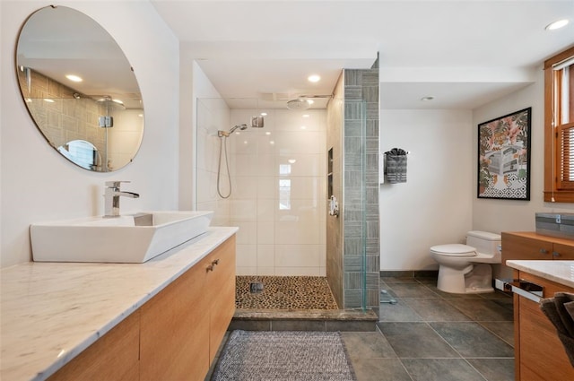 bathroom with vanity, toilet, and an enclosed shower