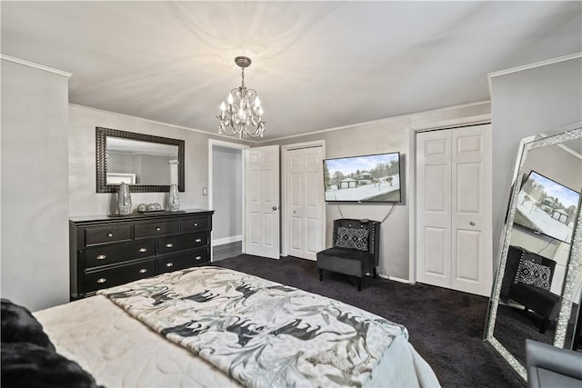 bedroom featuring a chandelier, ornamental molding, and two closets