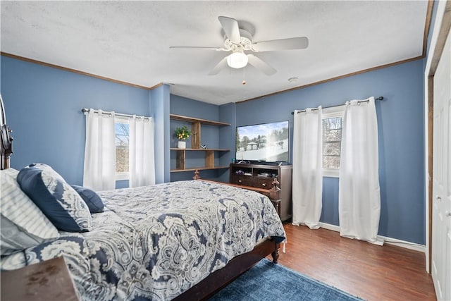 bedroom with multiple windows, a closet, ceiling fan, and dark wood-type flooring