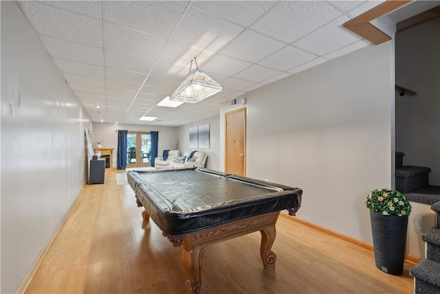 playroom with a paneled ceiling, billiards, and light hardwood / wood-style flooring