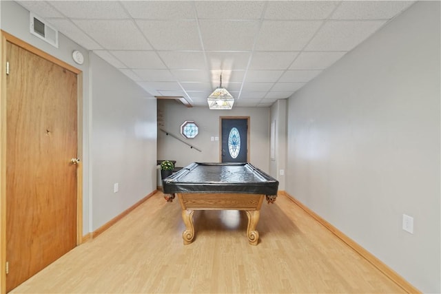 rec room with a paneled ceiling, hardwood / wood-style flooring, and pool table