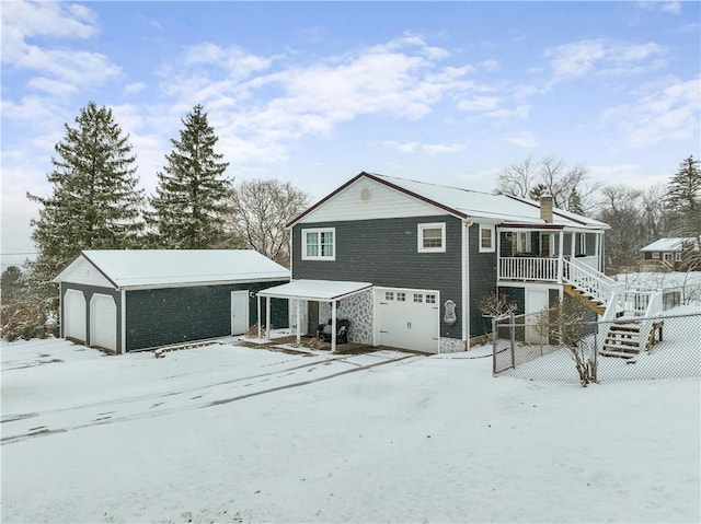 view of snow covered rear of property