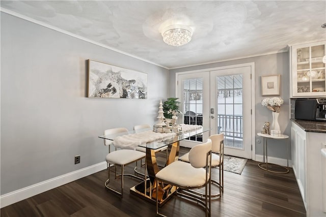 dining space featuring french doors, dark hardwood / wood-style floors, and crown molding