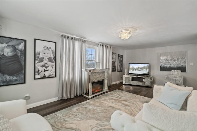 living room featuring dark hardwood / wood-style flooring and a chandelier