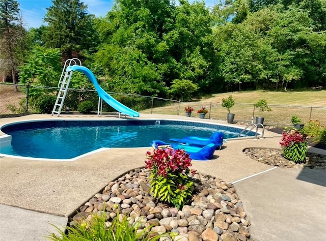 view of swimming pool featuring a patio area and a water slide