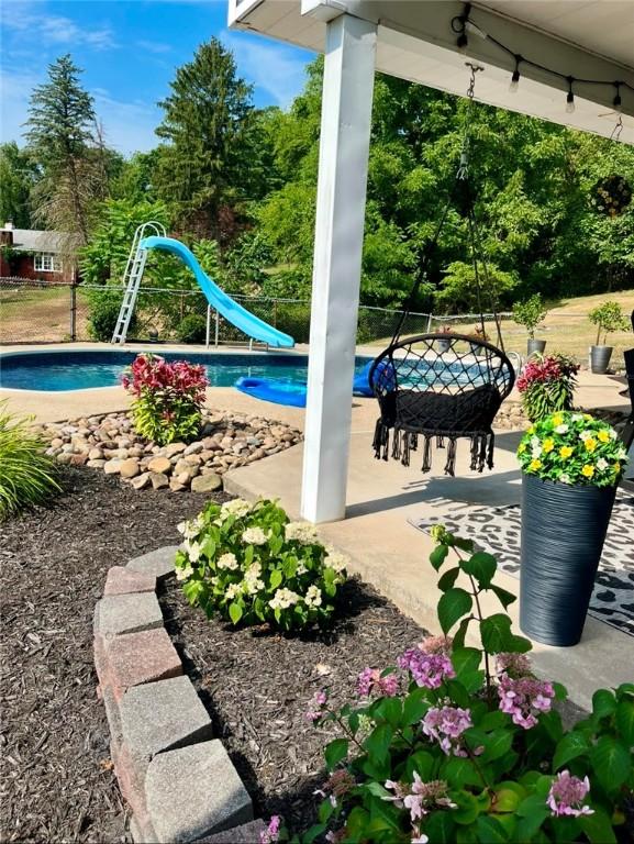 view of pool with a patio and a water slide