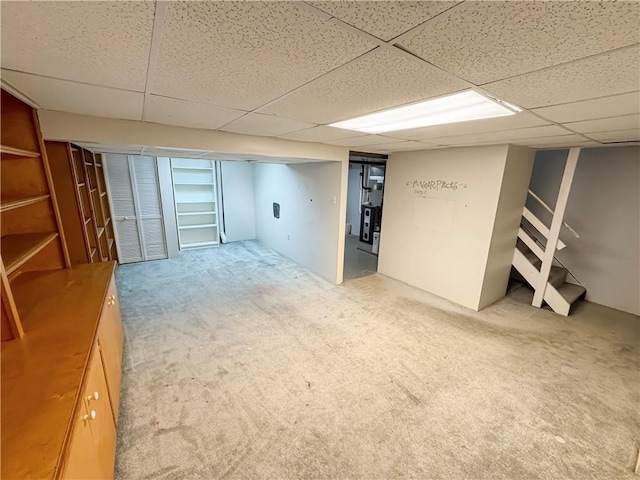 basement featuring carpet floors and a drop ceiling