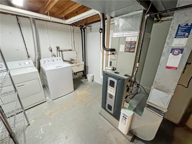 laundry room featuring washing machine and dryer, sink, and heating unit