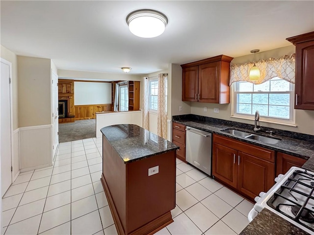 kitchen with stainless steel dishwasher, a center island, a healthy amount of sunlight, and sink