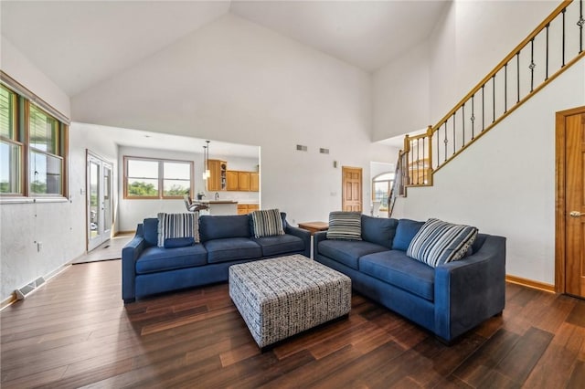 living room featuring dark hardwood / wood-style flooring and high vaulted ceiling