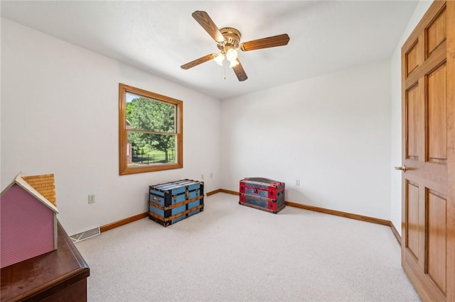 sitting room featuring light carpet and ceiling fan