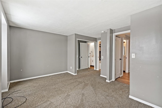 carpeted empty room with a textured ceiling