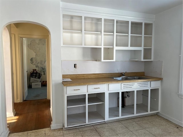 bar featuring butcher block counters and sink