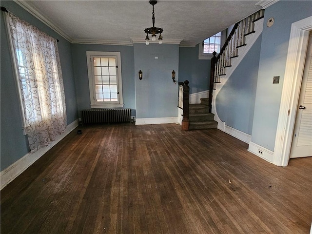 interior space featuring a wealth of natural light, a textured ceiling, dark hardwood / wood-style floors, and radiator