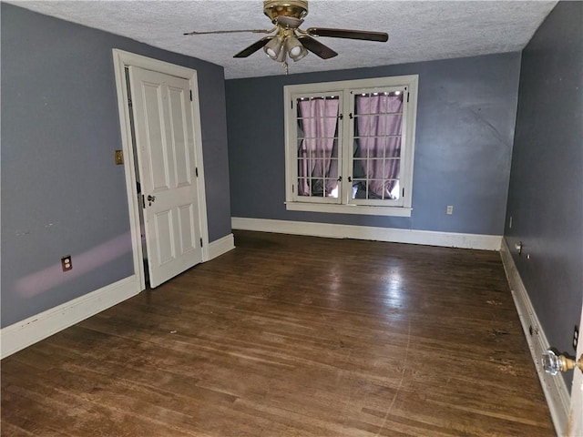 empty room with a textured ceiling, ceiling fan, and dark wood-type flooring