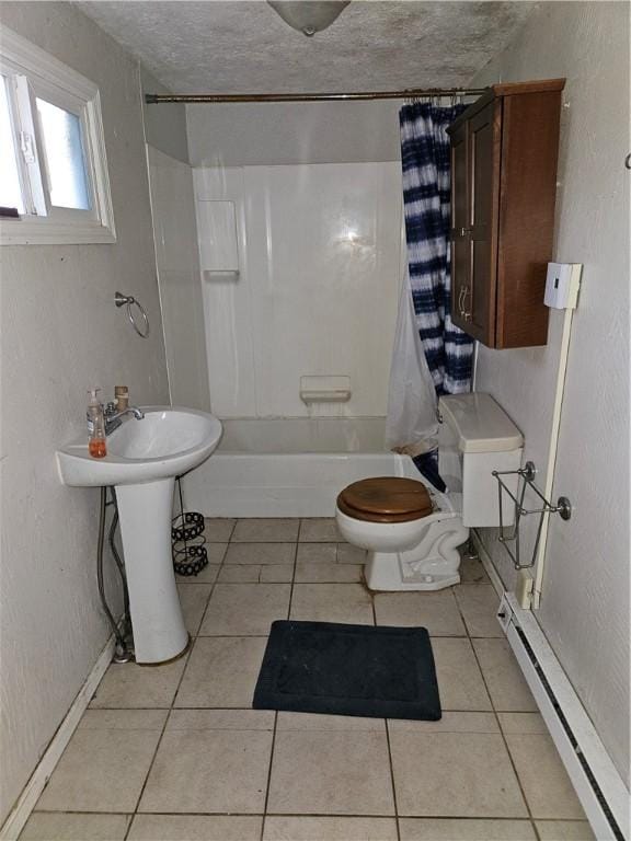 full bathroom with tile patterned floors, toilet, shower / bath combo with shower curtain, and a baseboard heating unit