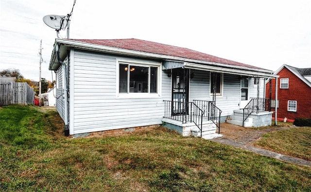 bungalow-style home with a front lawn