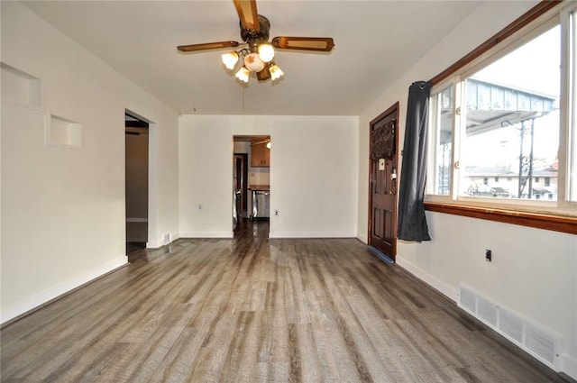 unfurnished living room featuring ceiling fan and wood-type flooring