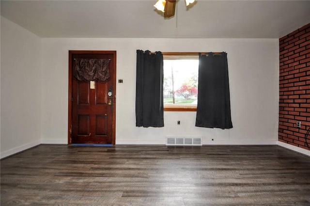 entrance foyer with ceiling fan and dark wood-type flooring