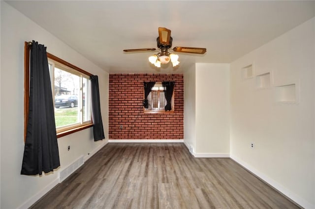 unfurnished room featuring ceiling fan and hardwood / wood-style flooring