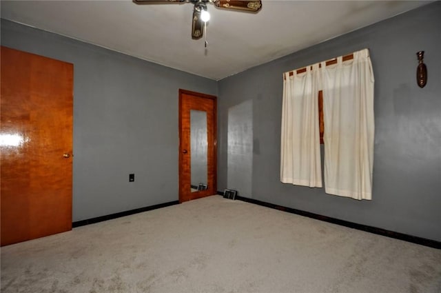 spare room with carpet flooring and ceiling fan