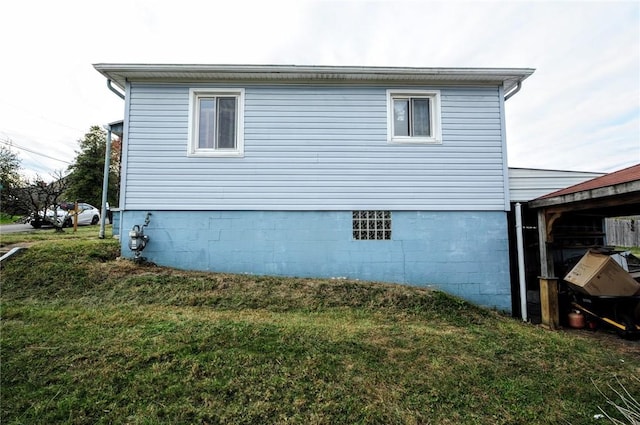 view of home's exterior with a lawn