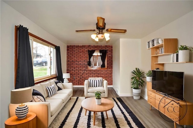 living room featuring wood-type flooring and ceiling fan