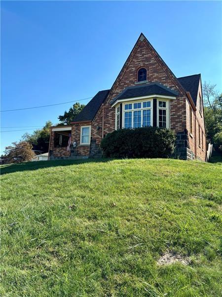 english style home with a front lawn