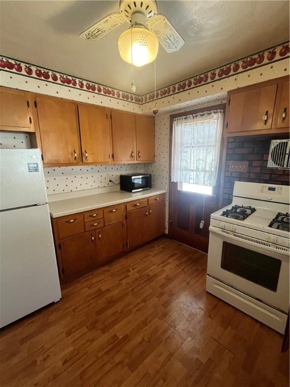 kitchen with ceiling fan, dark hardwood / wood-style floors, and white appliances