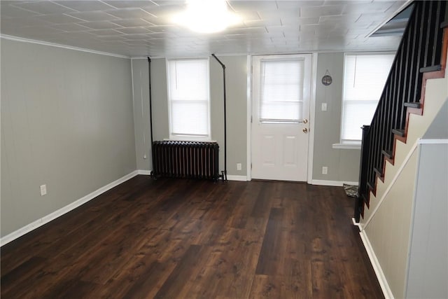 entrance foyer featuring radiator heating unit, dark hardwood / wood-style floors, and ornamental molding