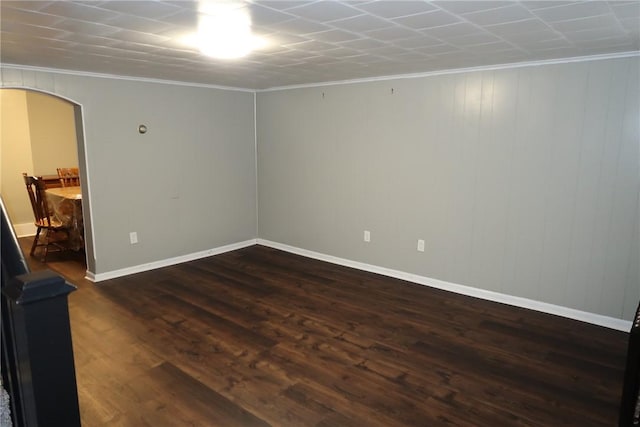 empty room featuring dark hardwood / wood-style flooring and ornamental molding