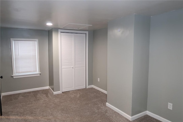 unfurnished bedroom featuring carpet and a closet