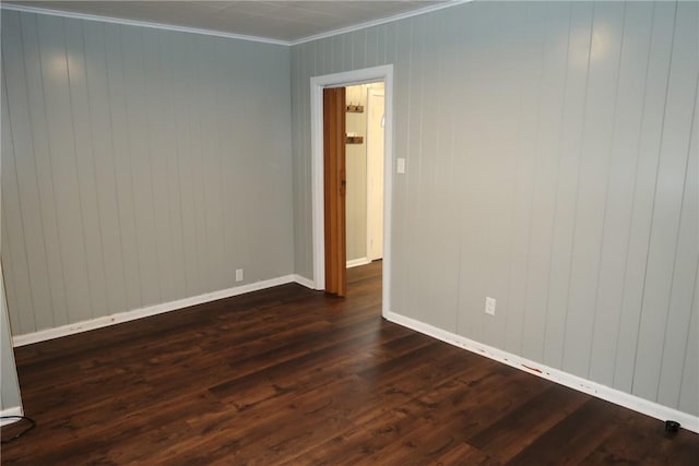 empty room with dark hardwood / wood-style floors and ornamental molding