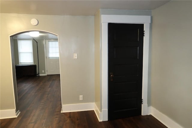 entryway featuring dark hardwood / wood-style flooring and radiator